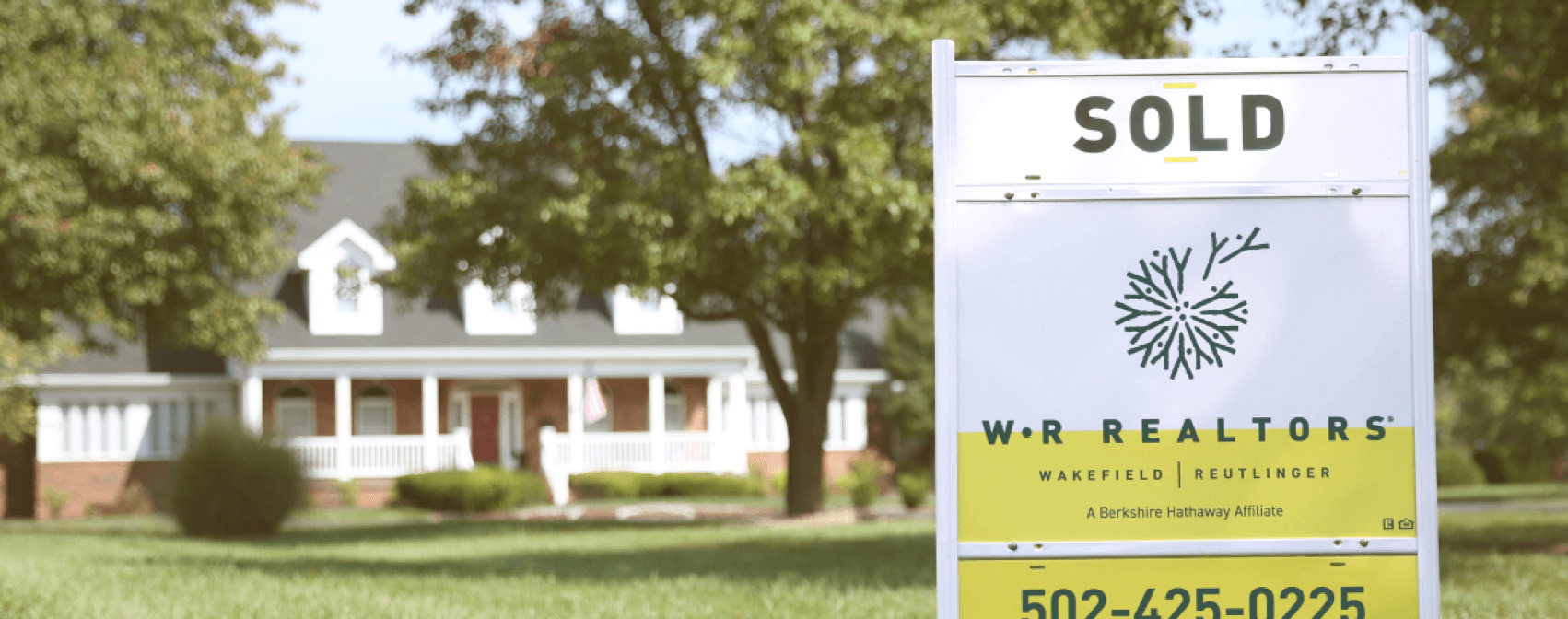 WR Realtors sold sign in front of house