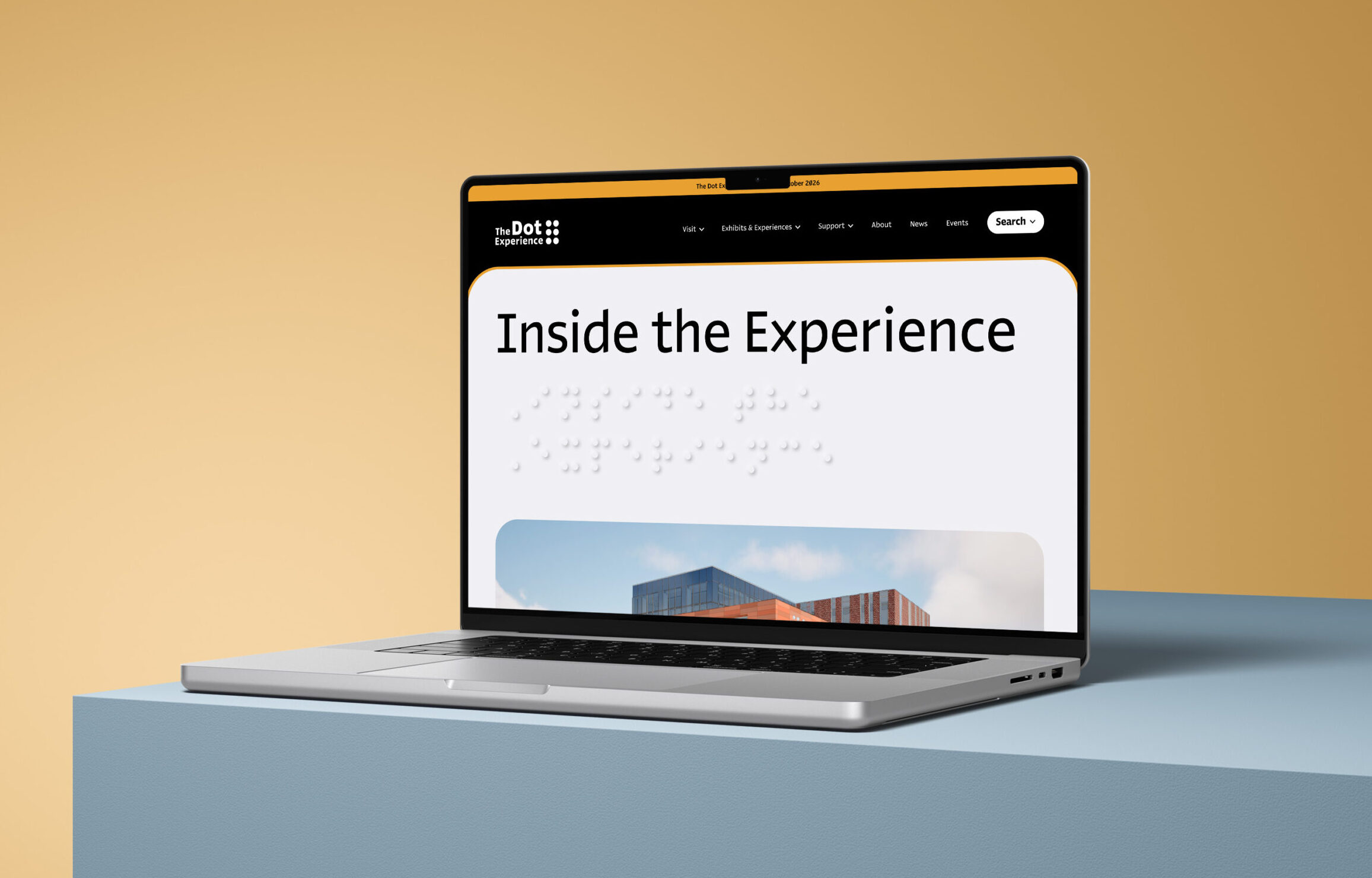 A laptop sits on a blue surface against a tan background, displaying a website with the heading “Inside the Experience” on its screen.