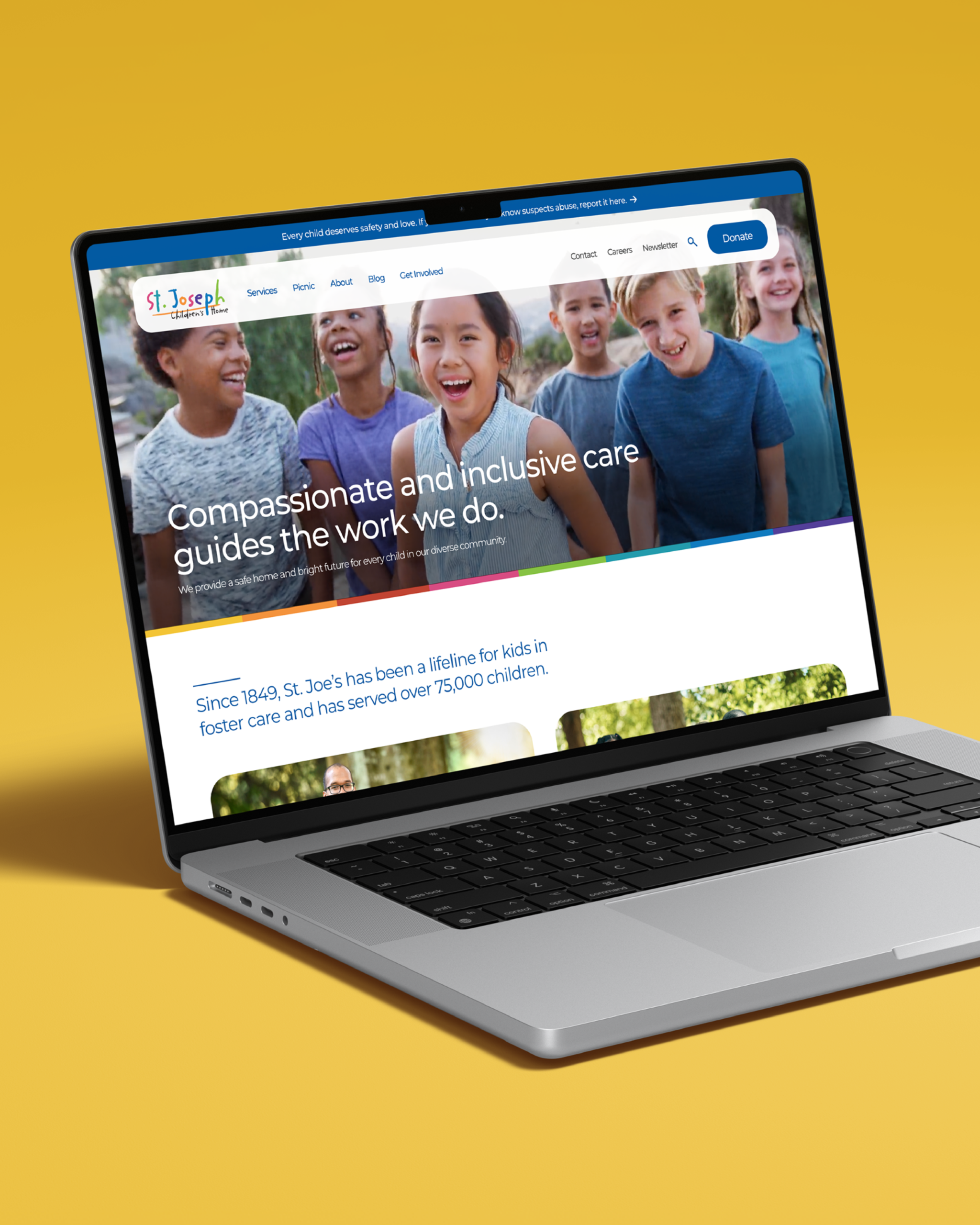 A laptop on a yellow background displays a website featuring smiling children and a headline about compassionate, inclusive care for kids in foster care.