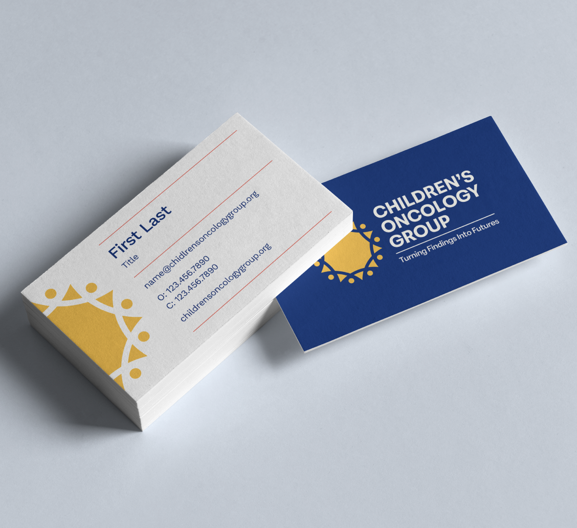 A stack of business cards for the Childrens Oncology Group, showing contact info on one side and the groups blue and yellow logo with the tagline Turning findings into futures on the other.