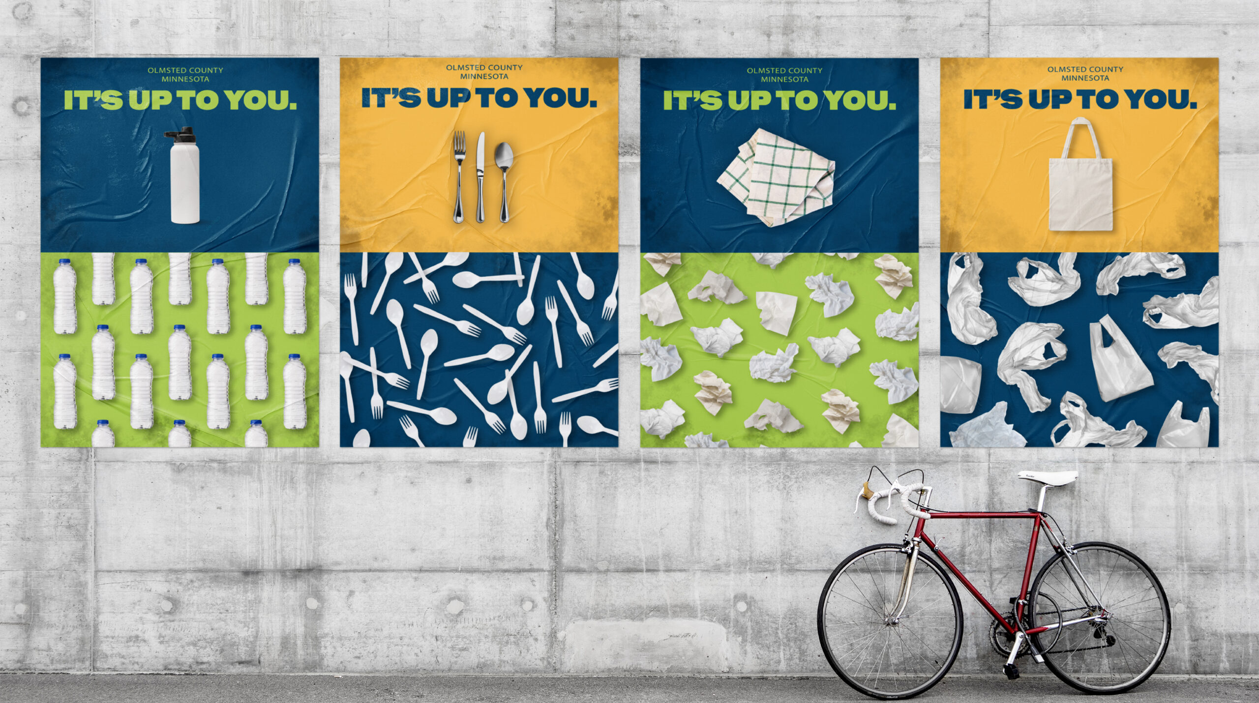 Four posters on a concrete wall titled Its Up To You from Olmsted County, Minnesota, each showing a reusable item above a pattern of its single-use plastic or paper counterpart.