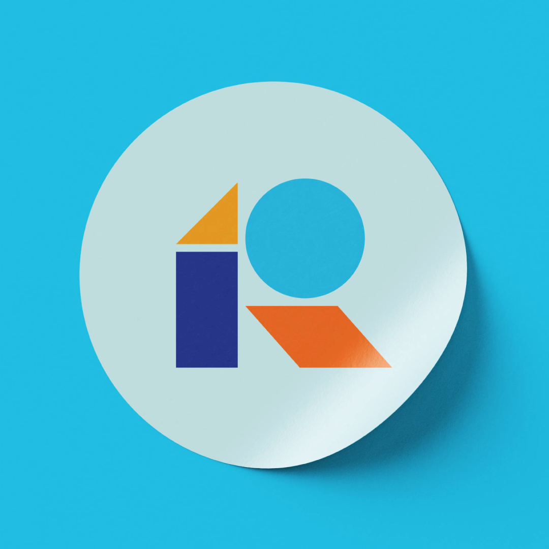 A circular sticker on a blue background featuring an abstract logo of the letter R composed of a blue rectangle, a yellow triangle, a blue circle, and an orange parallelogram.